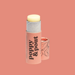 Image of an open pink lip balm tube with text "poppy and pout" on a salmon pink background