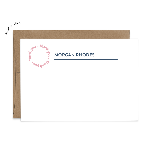 Image of a white flat note card and a kraft brown envelope. The card has the words “thank you” repeating in a circle shape in the top left corner and an example of a name with a line beneath the name.