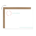Image of a white flat note card and a kraft brown envelope. The card has the words “with love from” repeating in a circle shape in the top left corner and an example of a name next to it. There is a line in the bottom right corner that extends off of the card.
