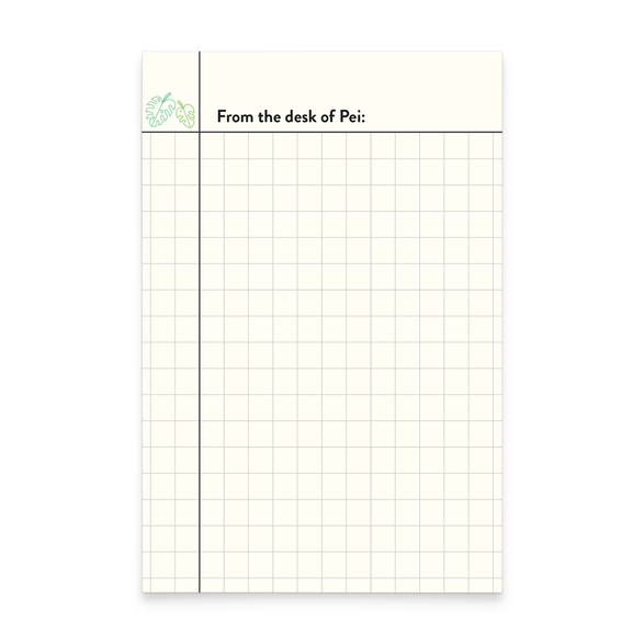 A photo of a graph notepad featuring a monstera leaf illustration in the top left corner and text that reads "From the desk of Pei"