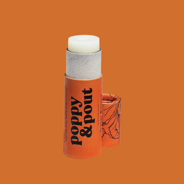 An image of an open orange lip balm tube with text "poppy and pout" on an orange background
