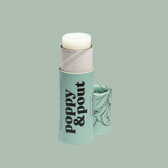 An image of an open mint green lip balm paper tube with text "poppy and pout" on a mint green background