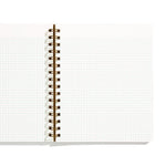 An image of an open notebook with graph paper pages and gold spiral binding