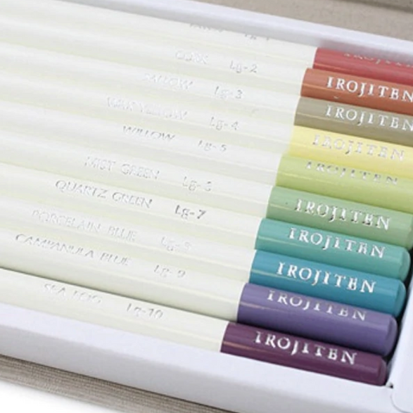 An up close image of colored pencils in a pastel color palette