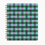 An image of a green, blue and purple plaid notebook with gold spiral binding on a white background. The cover of the notebook has a small section to label the name, date and subject.